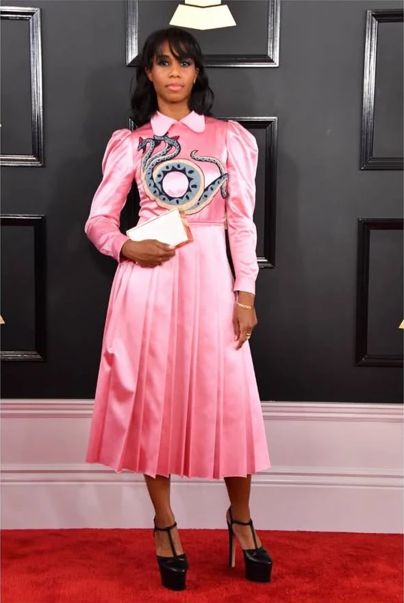 Full-length portrait of Santigold in a pink dress on the Grammys red carpet