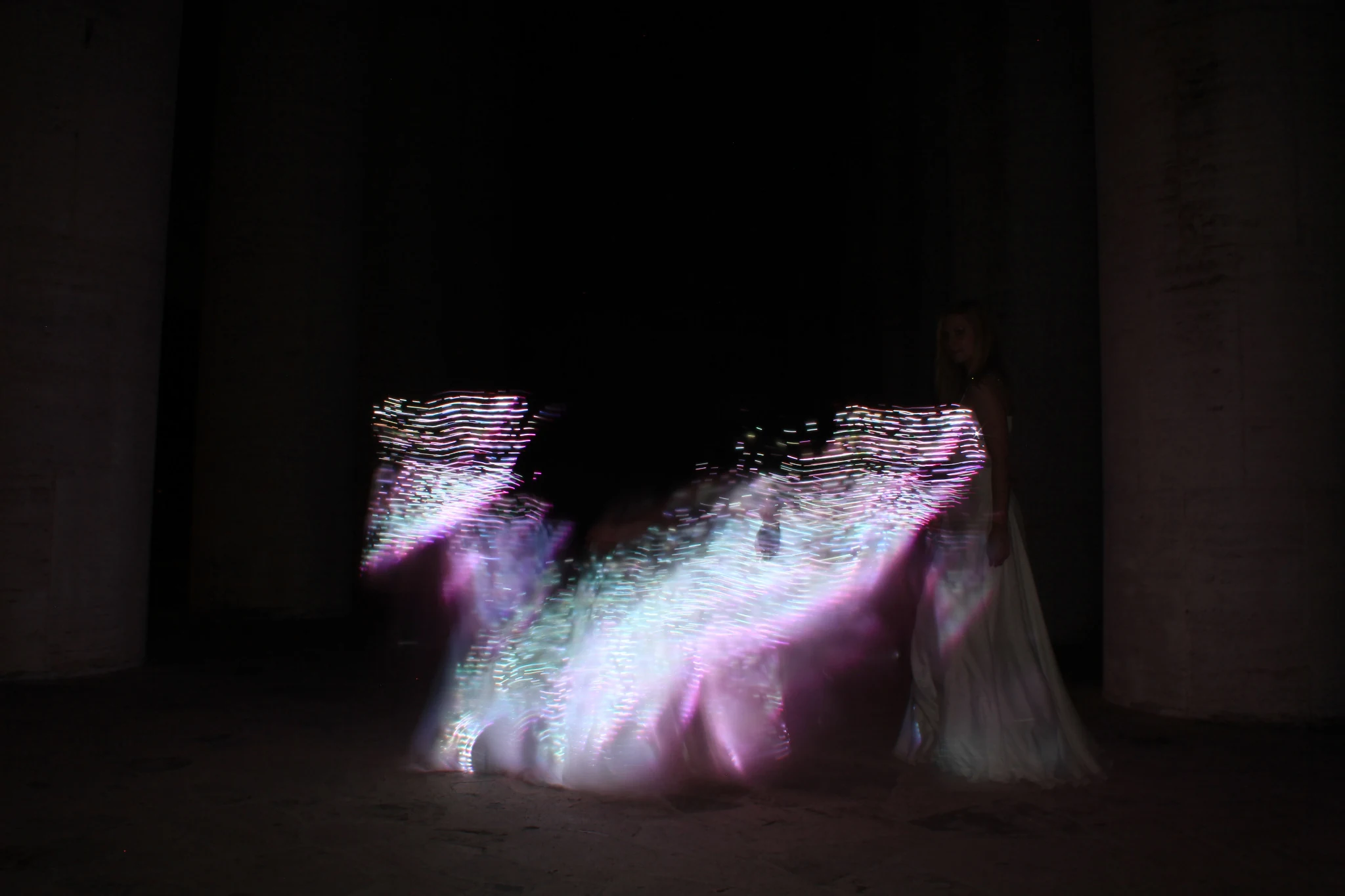 Aurora Dress illuminated in flowing pink and blue light