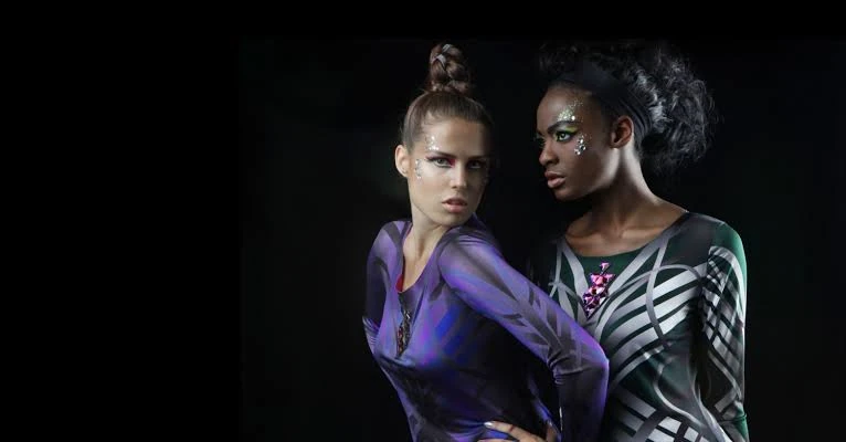 Two models in the Autumn Winter Paris collection against a dark background