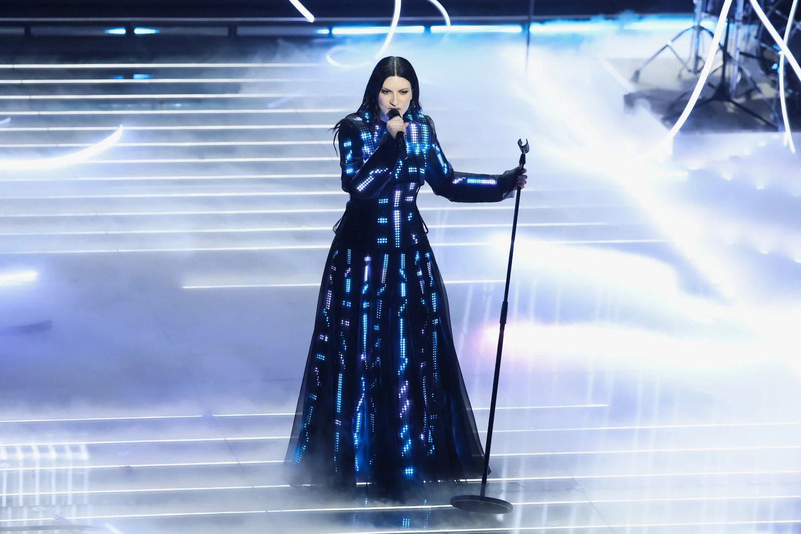 Laura Pausini on stage in a full-length illuminated black CuteCircuit gown